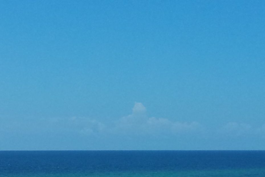 Calm ocean set against blue sky